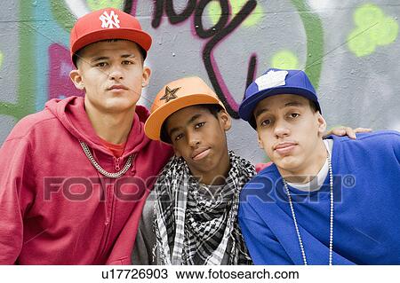 Teenage gang against graffiti wall View Large Photo Image Stock Image - Teenage gang against graffiti wall. Fotosearch