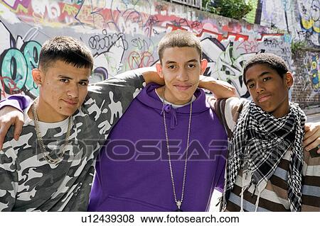 Teenage gang against graffiti wall View Large Photo Image Stock Photo - Teenage gang against graffiti wall. Fotosearch