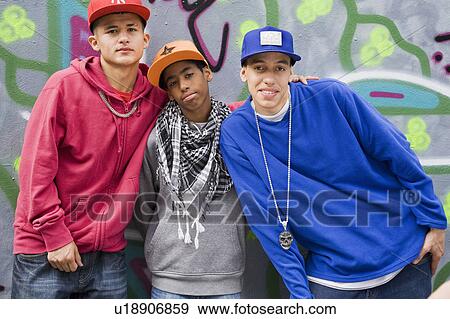 Stock Photo - Teenage gang against graffiti wall. Fotosearch