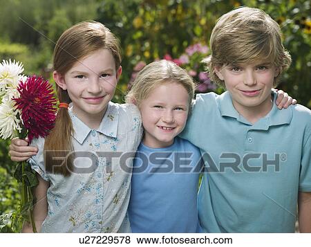 Three friends in a garden smiling View Large Photo Image Stock Photo - Three friends in a garden smiling. Fotosearch