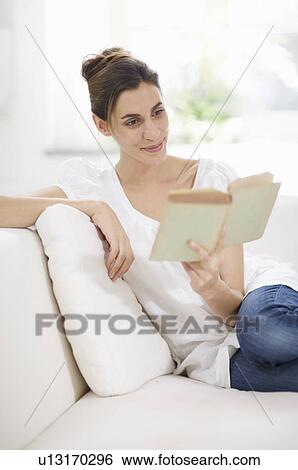 Stock Photograph - time to read and sit on the sofa. Fotosearch