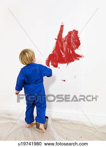 Toddler boy painting wall red. View Large Photo Image Stock Image - Toddler boy painting wall red.. Fotosearch
