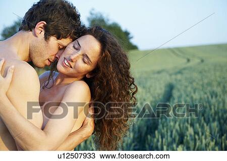 Stock Image - Topless couple, holding each other. Fotosearch