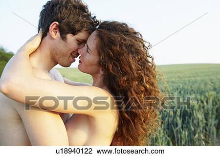 Stock Image - Topless couple, holding each other. Fotosearch