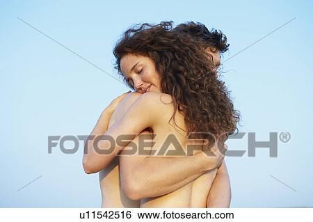 Topless couple, holding each other View Large Photo Image Stock Photograph - Topless couple, holding each other. Fotosearch