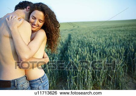 Stock Photograph - Topless couple, holding each other. Fotosearch