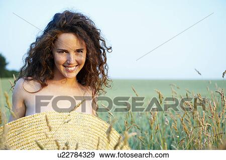 Stock Photo - Topless woman with hat before her chest. Fotosearch