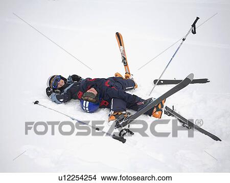 Two boys fallen in snow wearing skis View Large Photo Image Picture - Two boys fallen in snow wearing skis. Fotosearch