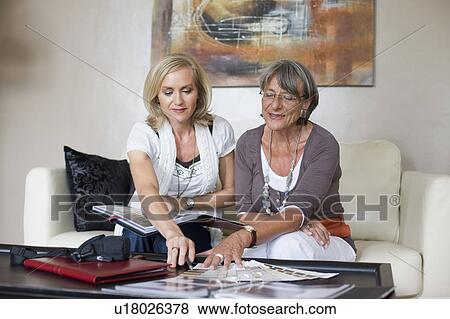 Stock Photo - two businesswomen having a conversation. Fotosearch
