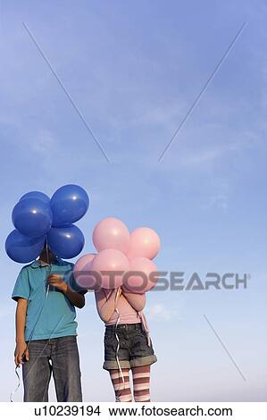 two children hidden behind balloons View Large Photo Image Picture - two children hidden behind balloons. Fotosearch