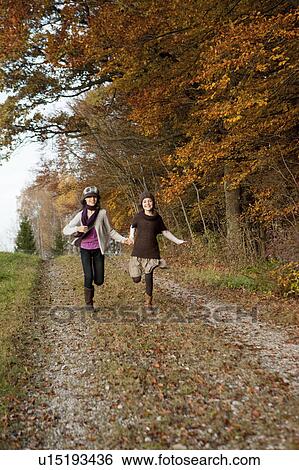 Stock Photograph - Two girls running. Fotosearch
