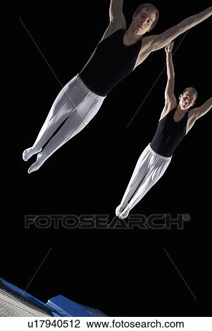 two male trampolinists mid flight View Large Photo Image Stock Image - two male trampolinists mid flight. Fotosearch