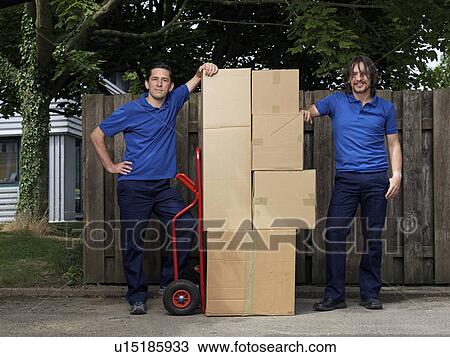 two men delivering boxes on trolley View Large Photo Image Stock Image - two men delivering boxes on trolley. Fotosearch