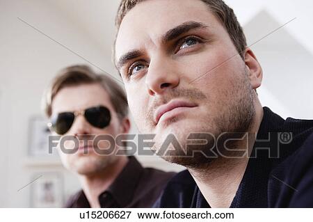 Stock Photo - two men looking serious. Fotosearch
