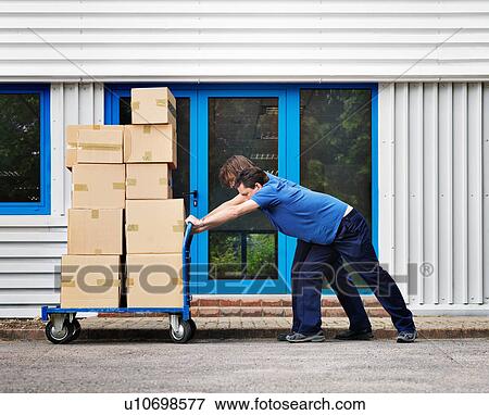 two men moving boxes on trolley View Large Photo Image Stock Photo - two men moving boxes on trolley. Fotosearch