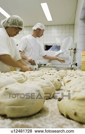 Stock Photo - Two people in a bakery with rolls. Fotosearch