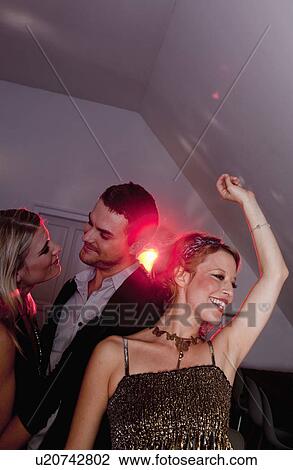 Stock Image - two women and a man dancing. Fotosearch