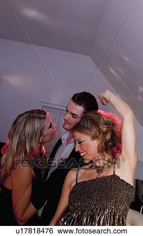 two women and a man dancing View Large Photo Image Stock Photograph - two women and a man dancing. Fotosearch