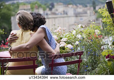 two women hugging on balcony View Large Photo Image Picture - two women hugging on balcony. Fotosearch