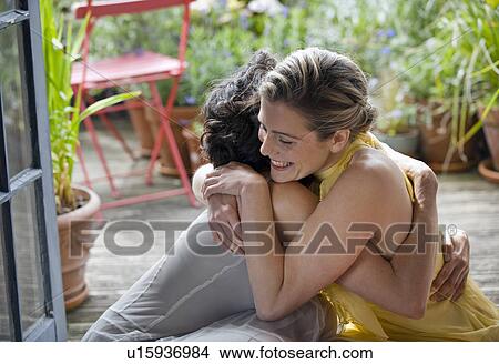 two women hugging on balcony View Large Photo Image Picture - two women hugging on balcony. Fotosearch