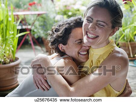 two women hugging on balcony View Large Photo Image Stock Photography - two women hugging on balcony. Fotosearch