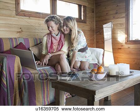 two women in a beach house, using laptop View Large Photo Image Stock Photography - two women in a beach house, using laptop. Fotosearch