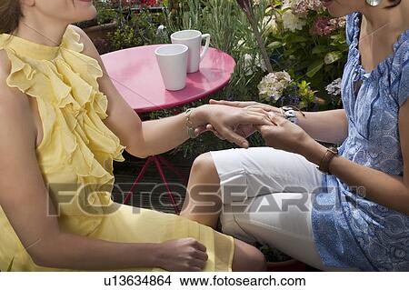 two women looking at hands View Large Photo Image Picture - two women looking at hands. Fotosearch