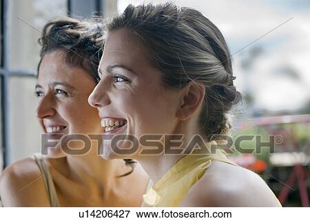 Stock Photo - two women smiling. Fotosearch