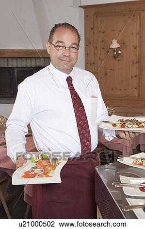 waiter serving plates of food View Large Photo Image Stock Image - waiter serving plates of food. Fotosearch