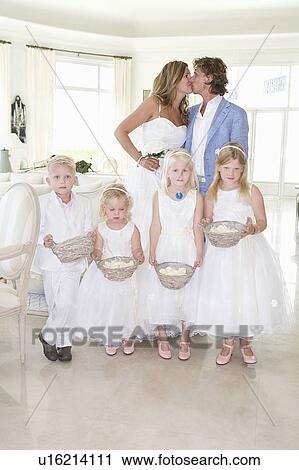Wedding couple kiss with kids View Large Photo Image Stock Image - Wedding couple kiss with kids. Fotosearch