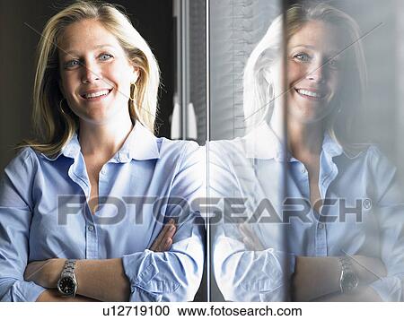 Woman against window, smiling View Large Photo Image Stock Image - Woman against window, smiling. Fotosearch