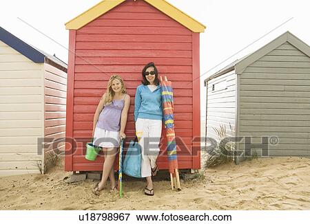 Woman and girl in front of beach huts View Large Photo Image Stock Photo - Woman and girl in front of beach huts. Fotosearch