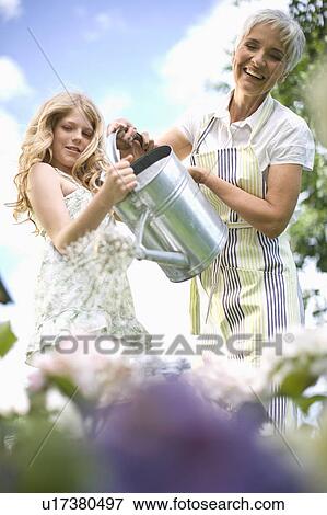 woman and girl in garden View Large Photo Image Stock Photo - woman and girl in garden. Fotosearch