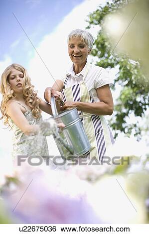 Stock Photograph - woman and girl in garden. Fotosearch