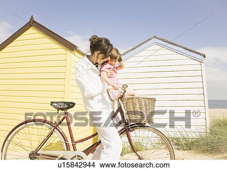 Woman and girl with bike View Large Photo Image Picture - Woman and girl with bike. Fotosearch