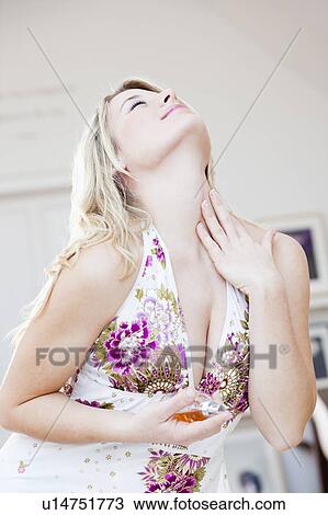 woman appreciatively applying perfume View Large Photo Image Stock Image - woman appreciatively applying perfume. Fotosearch