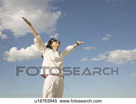 Stock Photography - Woman arms outstretched. Fotosearch