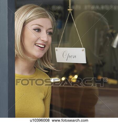 Stock Photo - woman at glass door. Fotosearch