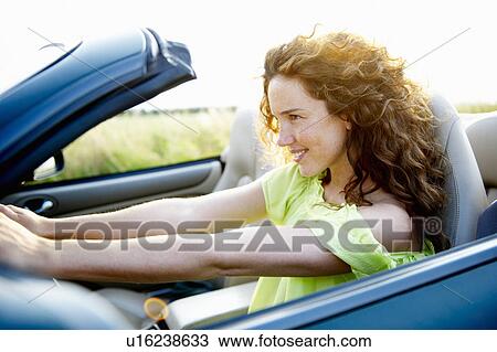Woman behind the wheel View Large Photo Image Stock Image - Woman behind the wheel. Fotosearch