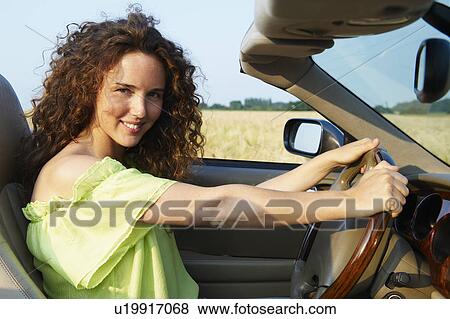 Woman behind the wheel View Large Photo Image Stock Photo - Woman behind the wheel. Fotosearch