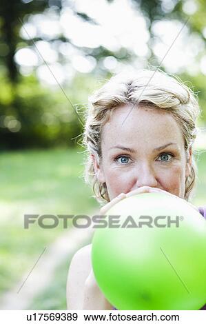 woman blowing up balloon View Large Photo Image Stock Photo - woman blowing up balloon. Fotosearch