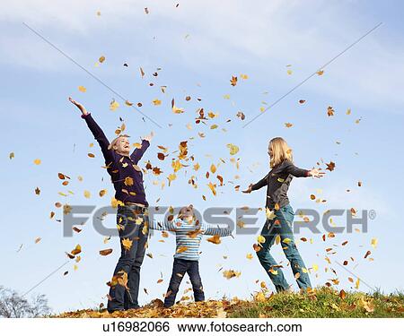 woman, boy and girl throw autumn leaves View Large Photo Image Stock Photograph - woman, boy and girl throw autumn leaves. Fotosearch