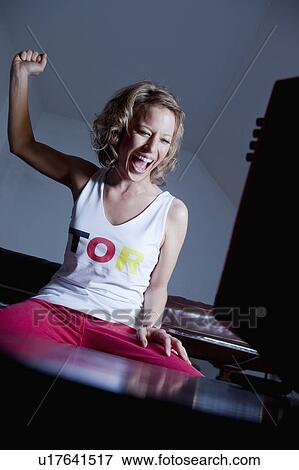 Stock Photo - woman cheering. Fotosearch