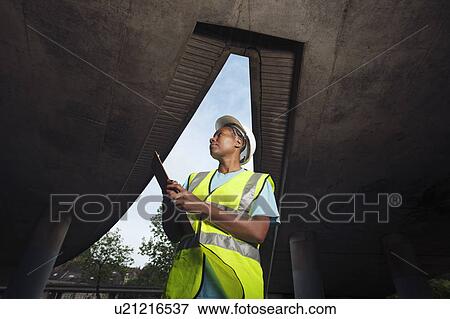 Stock Photo - woman documenting construction. Fotosearch