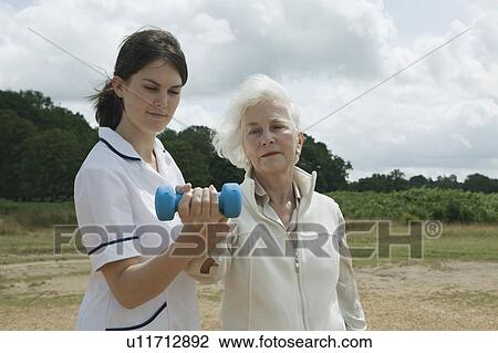 Woman doing exercises with weights View Large Photo Image Stock Image - Woman doing exercises with weights. Fotosearch