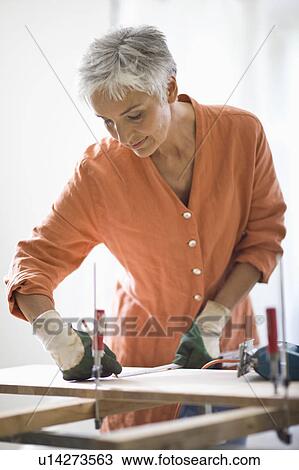 Stock Image - woman doing mechanical skills. Fotosearch