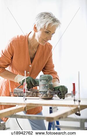 Stock Image - woman doing mechanical skills. Fotosearch