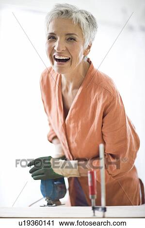 Stock Image - woman doing mechanical skills. Fotosearch
