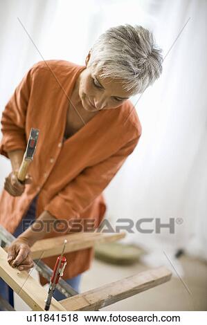 Stock Photo - woman doing mechanical skills. Fotosearch