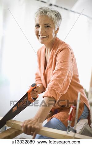 Stock Photo - woman doing mechanical skills. Fotosearch